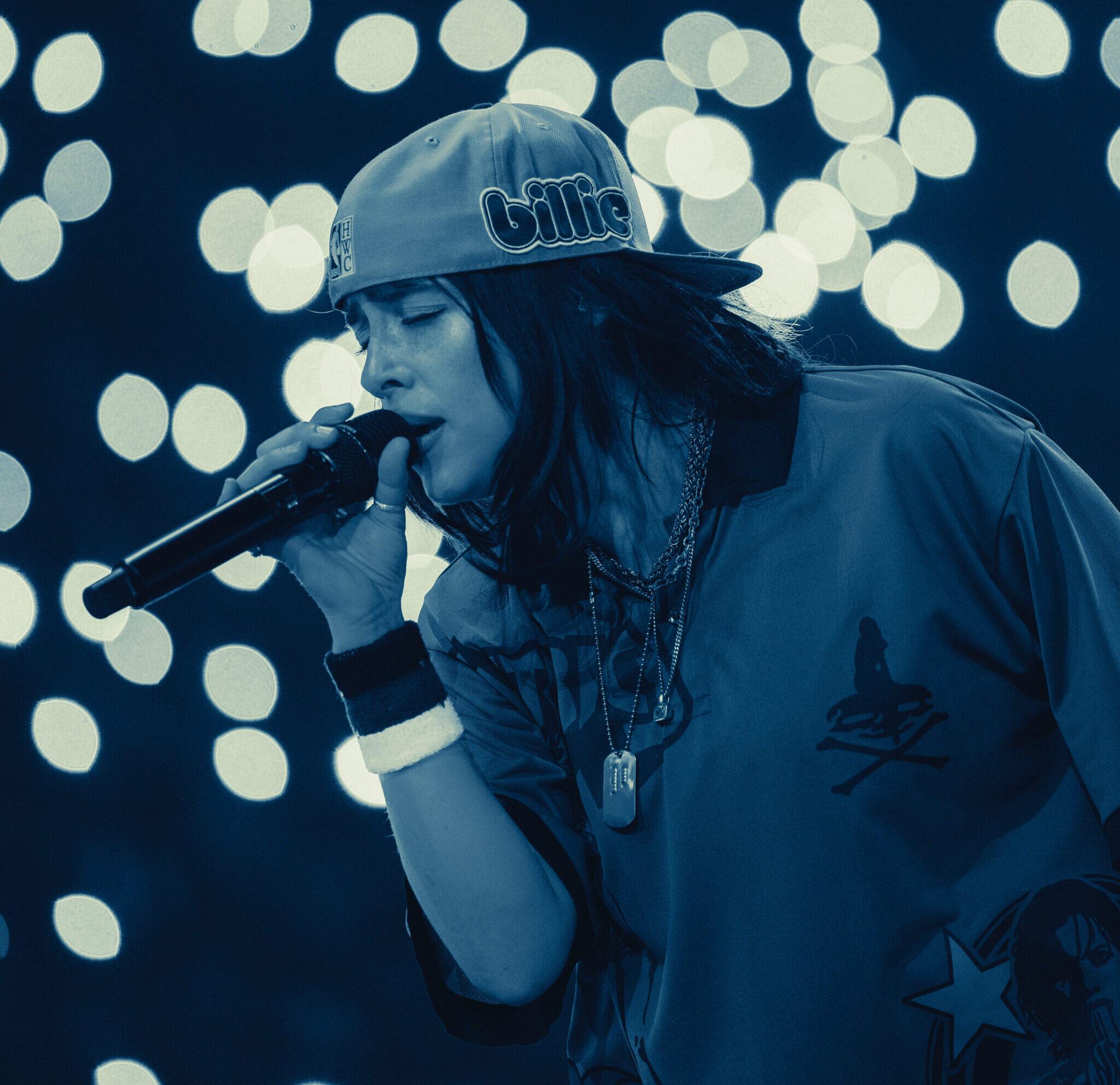 Billie Eilish performing into a microphone